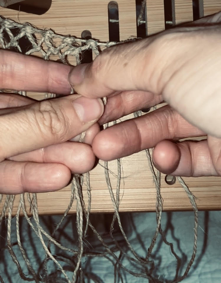 hands weaving string