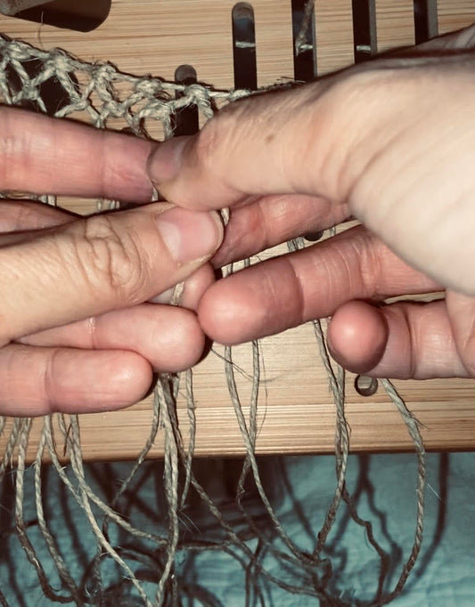 hands weaving string